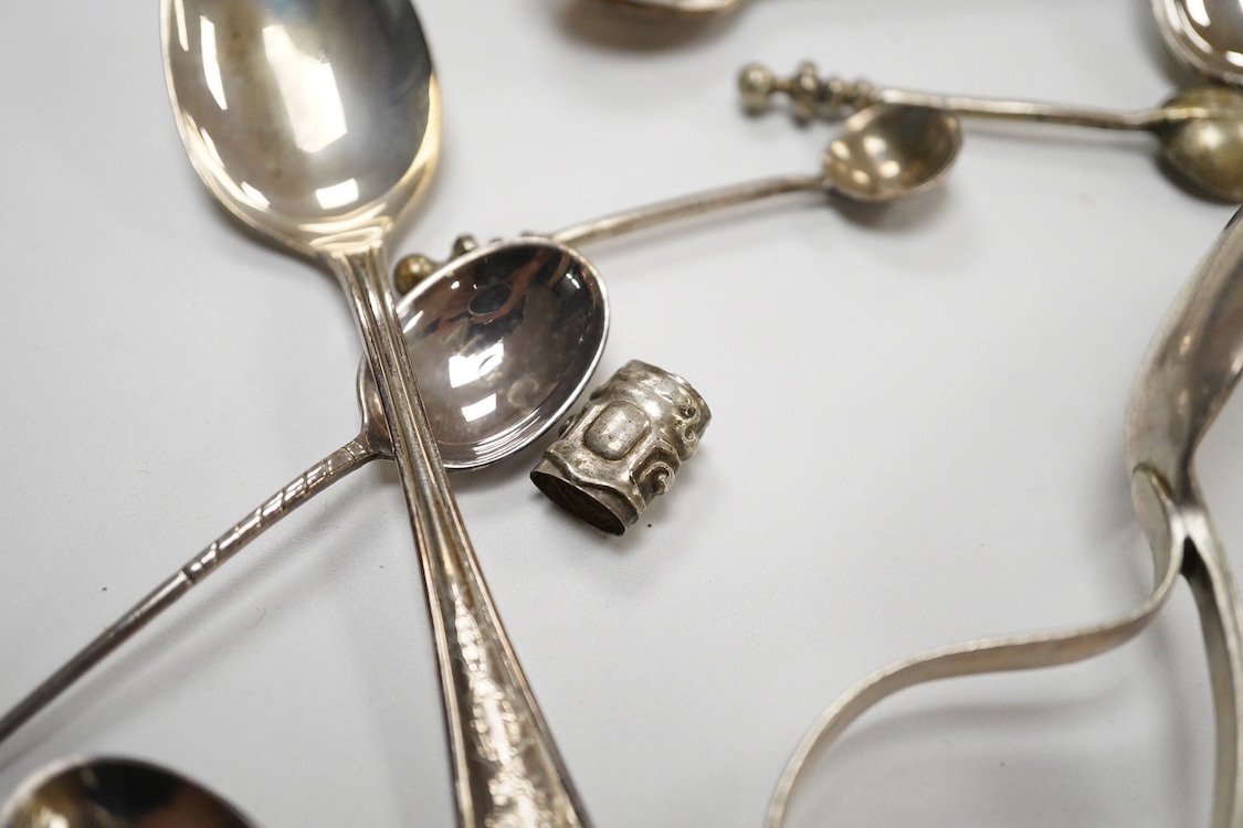 A small quantity of assorted small silver and plated flatware, a small silver stand, a silver napkin ring and a pair of modern silver mounted dwarf candlesticks.